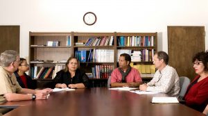 Seven people at meeting on office