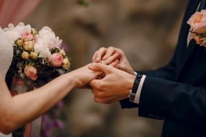 Groom Putting Ring On Bride S Finger