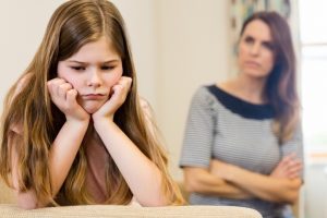 Daughter Sitting Upset With Her Mother In Living Room