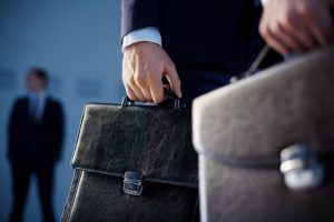 Close Up Of Workers With Briefcases