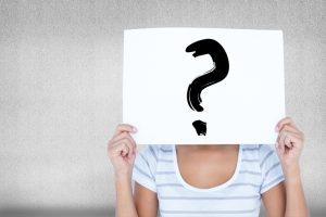 Woman With Sign In The Face With Question Mark